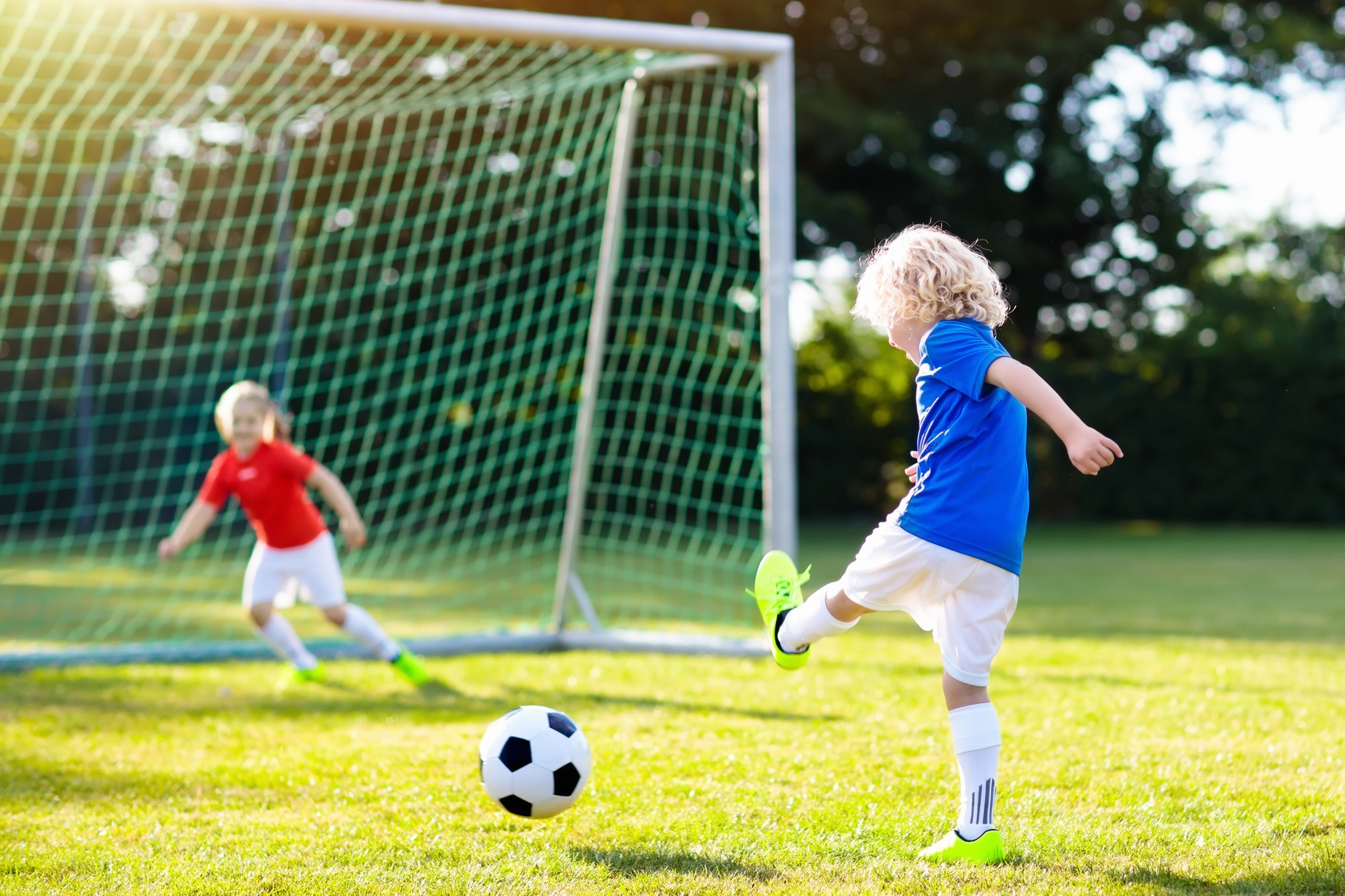 Kids play football. Child at soccer field. | Pro-Kita.com